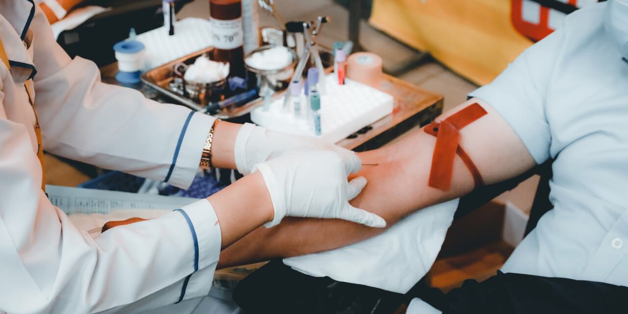 Healthcare professional in white gloves administering a COVID-19 vaccine injection to a patient's arm, symbolizing the completion of the vaccination process